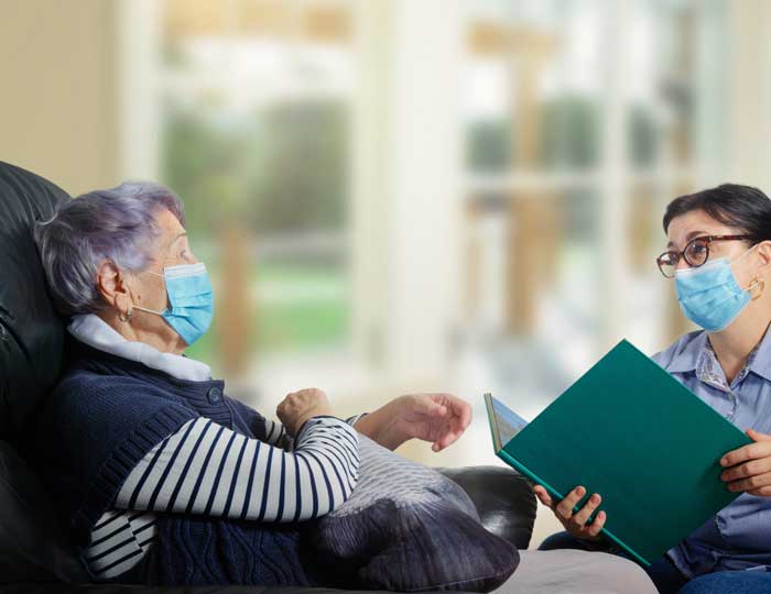 Older adult and caregiver talking to each other