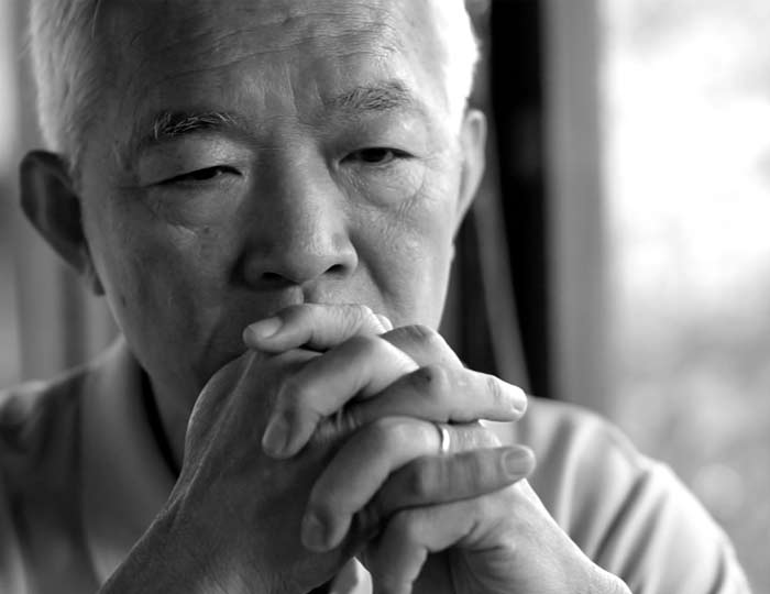 Thoughtful Asian older man