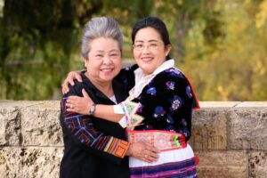 Photo of two people embracing and smiling for the camera.