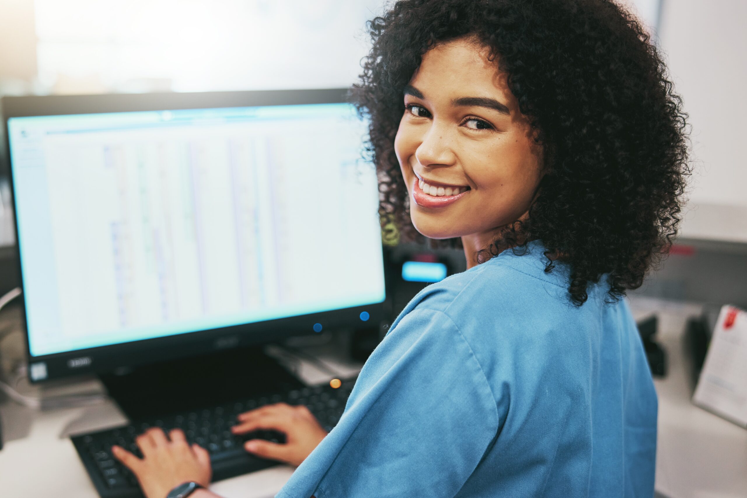 A woman receptionist smiling.