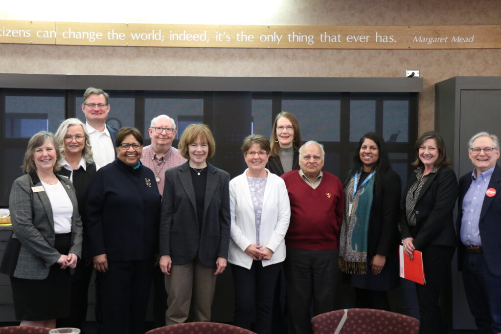 Photo of a group of 12 people, including Senator Tina Smith