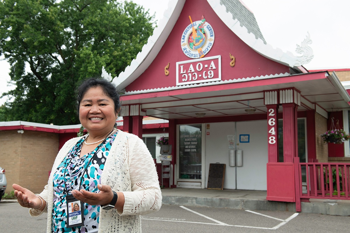 A photo of Lao Advancement Organization of America's Executive Director, Bounleuth Gowing, in front of the organization's building exterior.