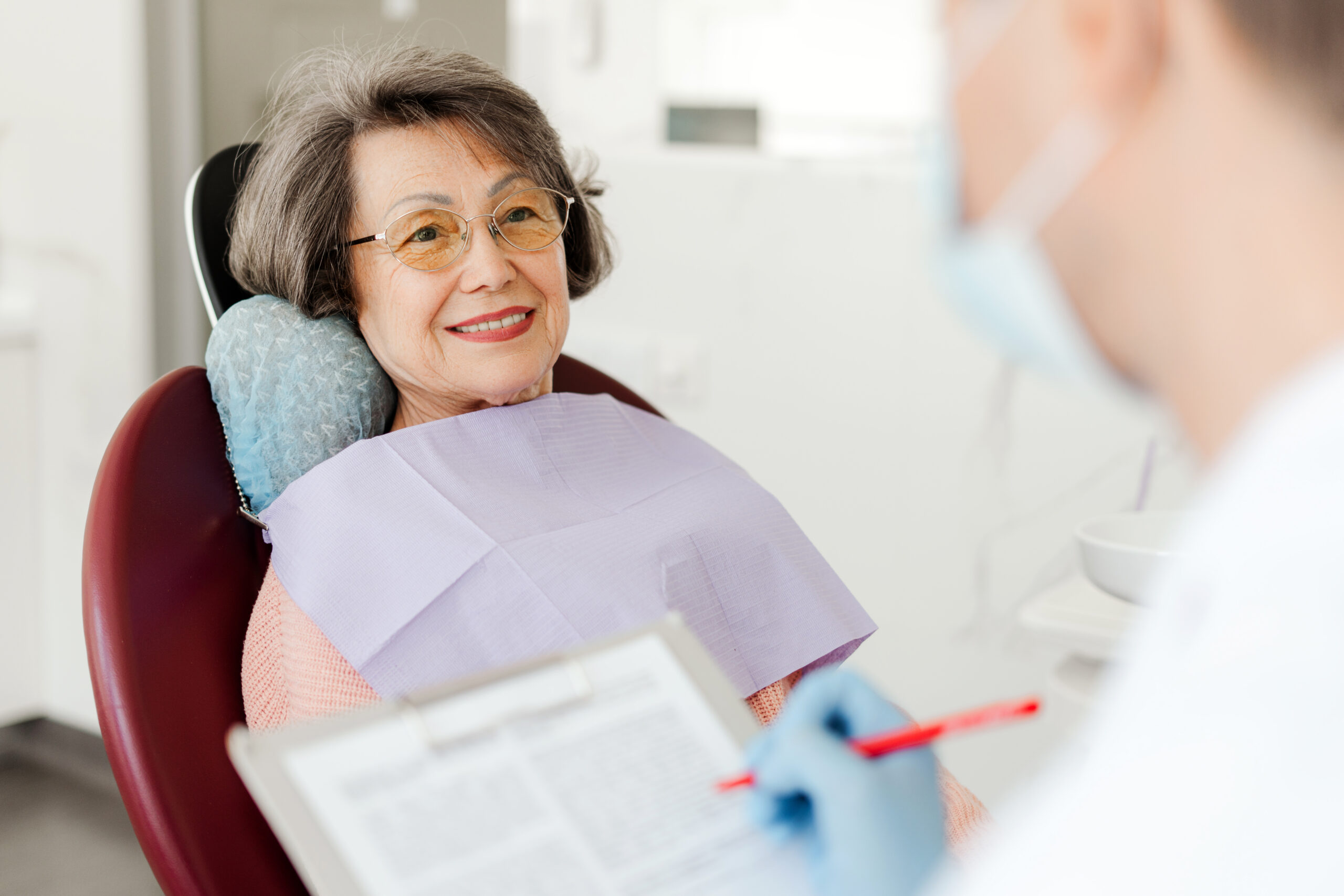 Photo of a person sitting in a dental exam chair.