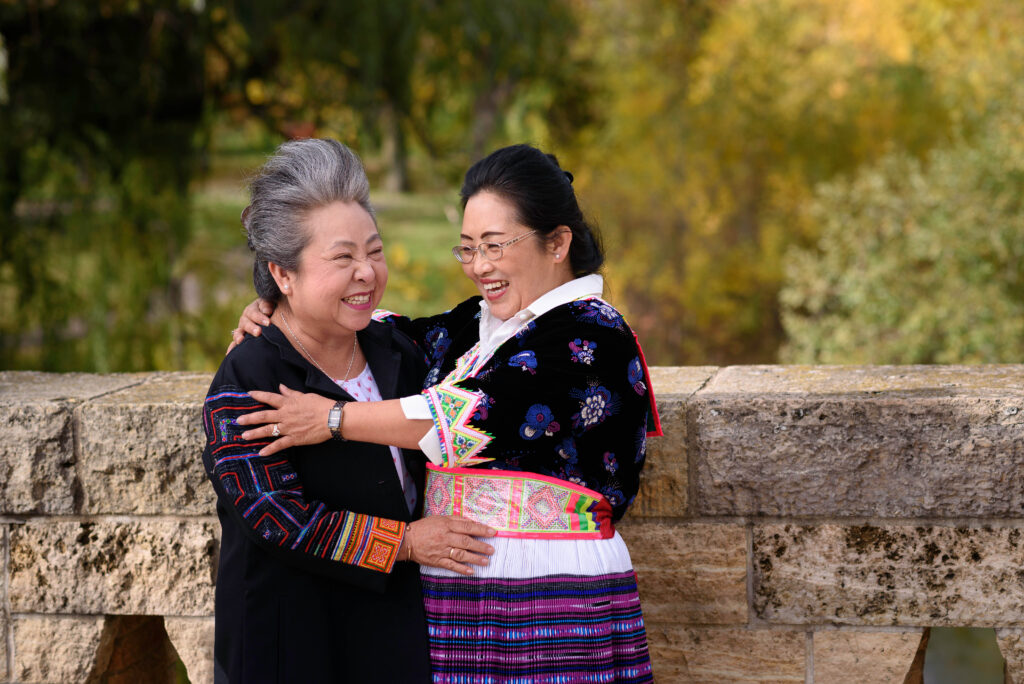 Photo of two women embracing and laughing.