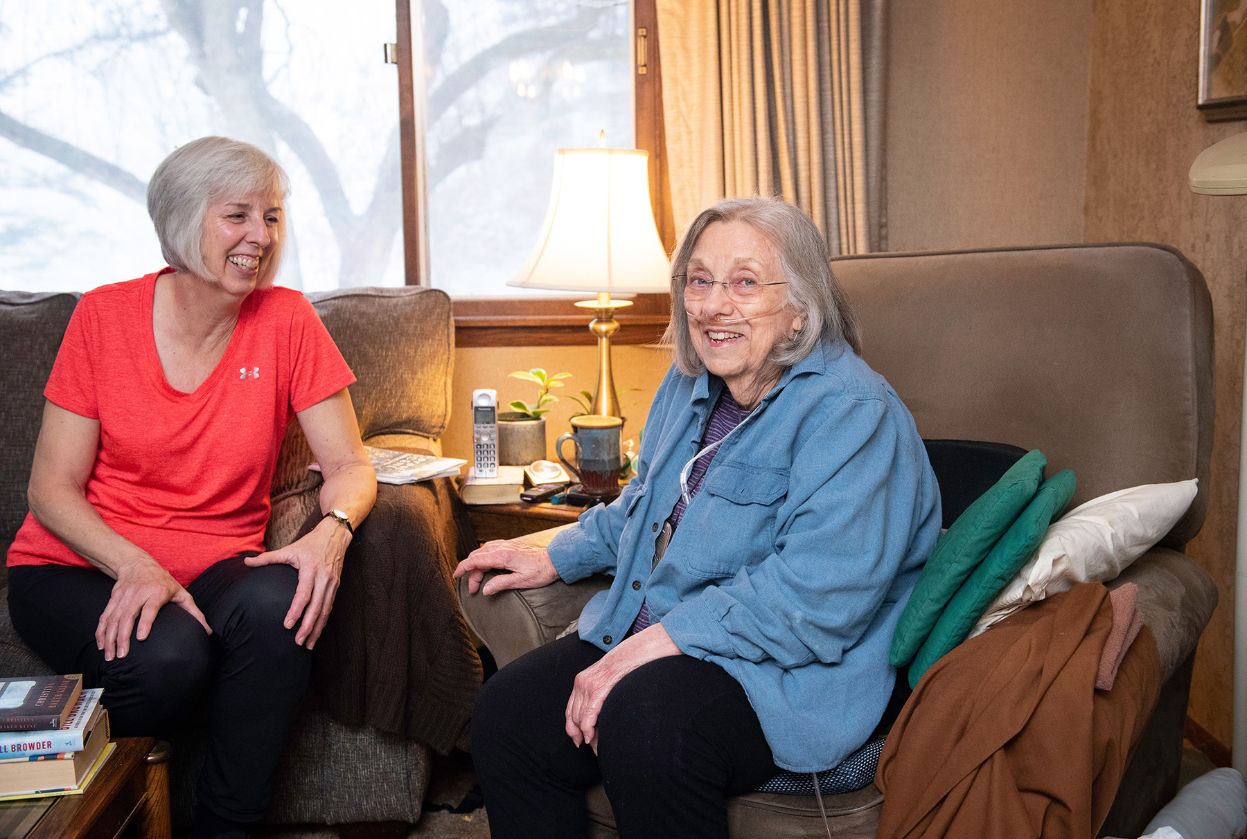 Two people sitting together smiling.