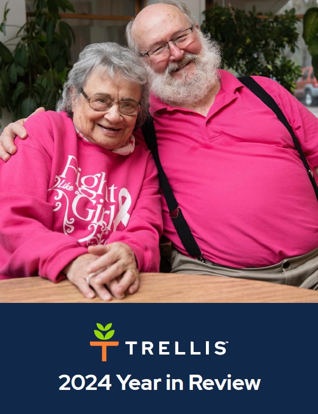 Photo of two people hugging. Beneath them, the words "Trellis 2024 Year in Review" appear in white text on a blue background.