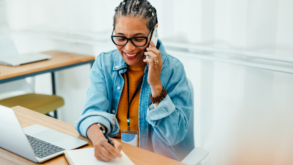 Photo of a woman speaking on a phone.