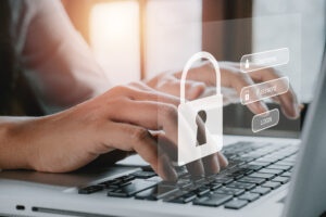 Graphic showing hands at a keyboard with a password lock screen hovering above.