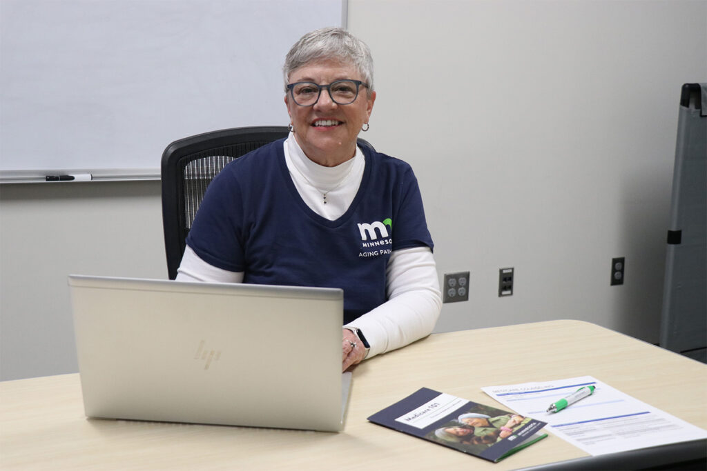 Photo of Jill Lord sitting at a desk in front of a laptop.